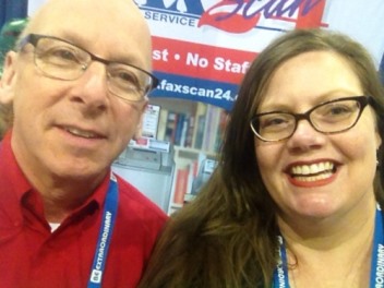 Prize-winner Amy Strohmer-Wood takes a selfie with the FaxScan24 Fax and Scan Service booth staff.